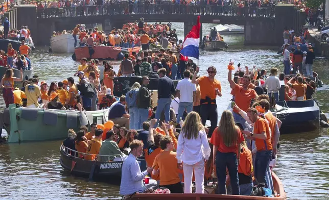 People celebrate King's Day in Amsterdam, Netherlands, Saturday, April 26, 2025. (AP Photo/Peter Dejong)