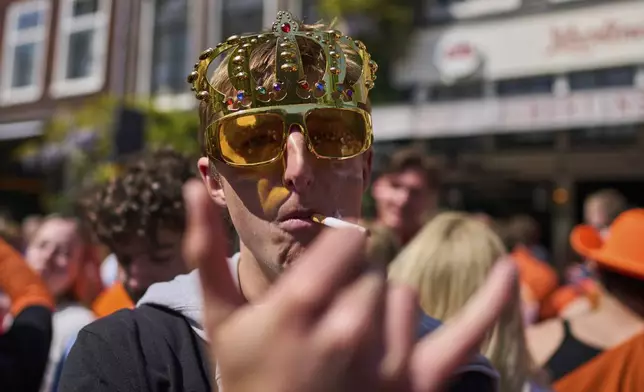 People celebrate King's Day in Amsterdam, Netherlands, Saturday, April 26, 2025. (AP Photo/Peter Dejong)