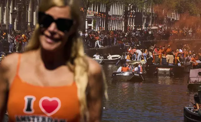 People celebrate King's Day in Amsterdam, Netherlands, Saturday, April 26, 2025. (AP Photo/Peter Dejong)
