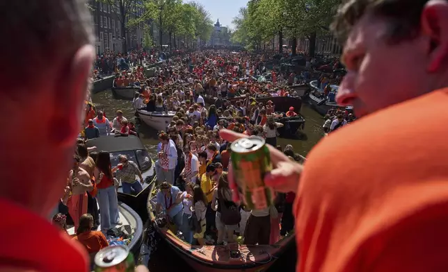 People celebrate King's Day in Amsterdam, Netherlands, Saturday, April 26, 2025. (AP Photo/Peter Dejong)