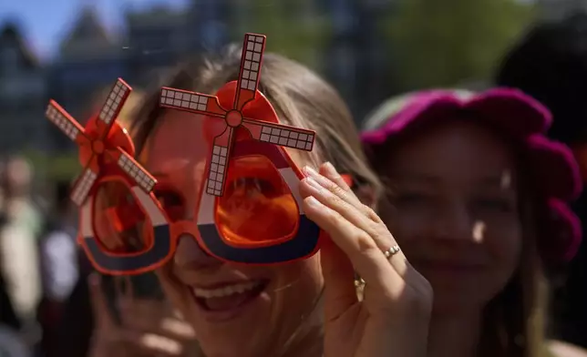 People celebrate King's Day in Amsterdam, Netherlands, Saturday, April 26, 2025. (AP Photo/Peter Dejong)