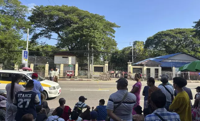 Family members and colleagues wait to welcome released prisoners outside the main gate of Insein prison during the country's traditional New Year day on Thursday, April 17, 2025, in Yangon, Myanmar. (AP Photo/Thein Zaw)