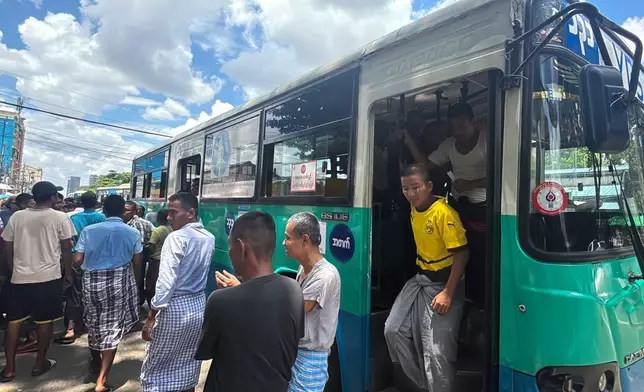 Released prisoners get out of a bus outside the main gate of Insein prison as the head of Myanmar’s military government granted amnesty to thousands of prisoners to mark the country's traditional New Year Thursday, April 17, 2025, in Yangon, Myanmar. (AP Photo/Thein Zaw)