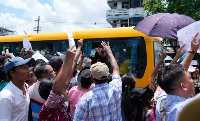 Released prisoners on a bus are welcomed by family members and colleagues outside the main gate of Insein prison as the head of Myanmar’s military government granted amnesty to thousands of prisoners to mark the country's traditional New Year Thursday, April 17, 2025, in Yangon, Myanmar. (AP Photo/Thein Zaw)