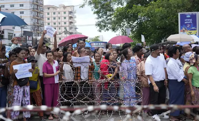 Family members and colleagues wait to welcome released prisoners outside the main gate of Insein prison as the head of Myanmar’s military government granted amnesty to thousands of prisoners to mark the country's traditional New Year Thursday, April 17, 2025, in Yangon, Myanmar. (AP Photo/Thein Zaw)
