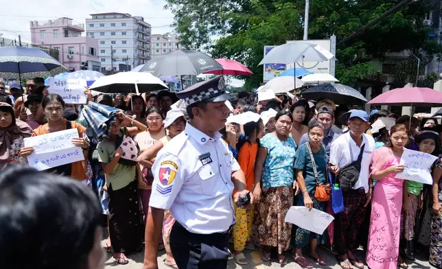 Family members and colleagues wait to welcome released prisoners outside the main gate of Insein prison as the head of Myanmar’s military government granted amnesty to thousands of prisoners to mark the country's traditional New Year Thursday, April 17, 2025, in Yangon, Myanmar. (AP Photo/Thein Zaw)