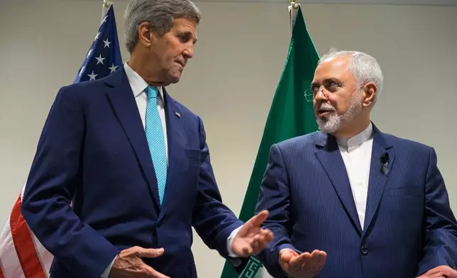 FILE - U.S. Secretary of State John Kerry, left, meets with Iranian Foreign Minister Mohammad Javad Zarif at United Nations headquarters, on Sept. 26, 2015. (AP Photo/Craig Ruttle, File)