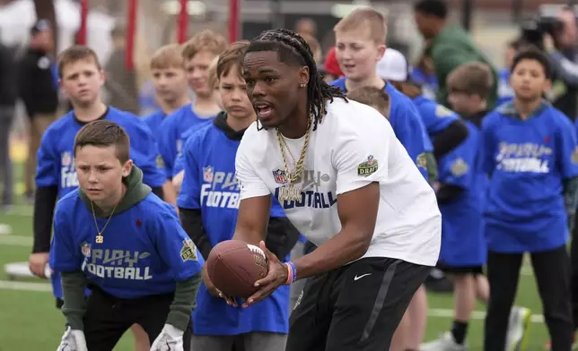 Draft prospect Maxwell Hairston, a cornerback from Kentucky, works with local youth football players and Special Olympics athletes during the league's annual prospect clinic ahead of the NFL football draft Wednesday, April 23, 2025, in Green Bay, Wis. (AP Photo/Jeff Roberson)