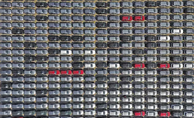 An aerial view of new cars waiting for shipment at a pier for "roll-on/roll-off" ships in Yantai city in eastern China's Shandong province Sunday, March 30, 2025. (Chinatopix via AP)