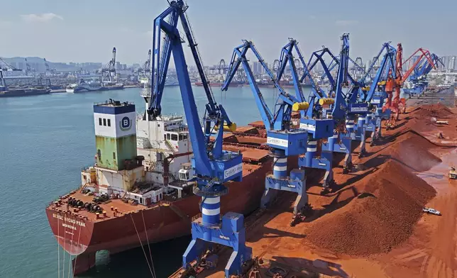 An aerial view of imported iron ore in a port in Yantai city in eastern China's Shandong province Sunday, March 30, 2025. (Chinatopix Via AP) CHINA OUT