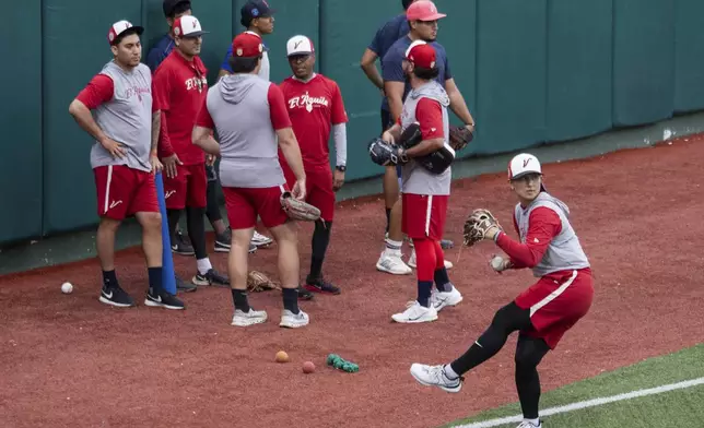 Player Kelsie Whitmore winds up before throwing a ball during a training session with the Aguila de Veracruz profesional baseball team in Veracruz, Mexico, Tuesday, April 8, 2025. (AP Photo/Victoria Razo)
