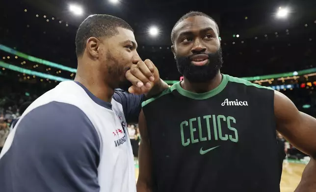 Boston Celtics' Jaylen Brown, right, talks with former teammate, Washington Wizards' Marcus Smart, following an NBA basketball game Sunday, April 6, 2025, in Boston. (AP Photo/Michael Dwyer)