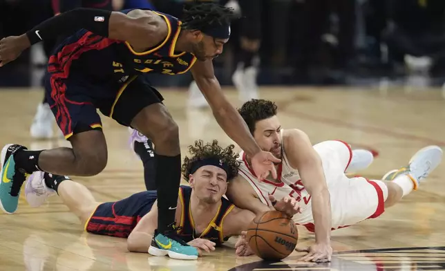 From left, Golden State Warriors guards Buddy Hield and Brandin Podziemski compete for possession of the ball with Houston Rockets center Alperen Sengun during the first half of Game 4 of an NBA basketball first-round playoff series Monday, April 28, 2025, in San Francisco. (AP Photo/Godofredo A. Vásquez)