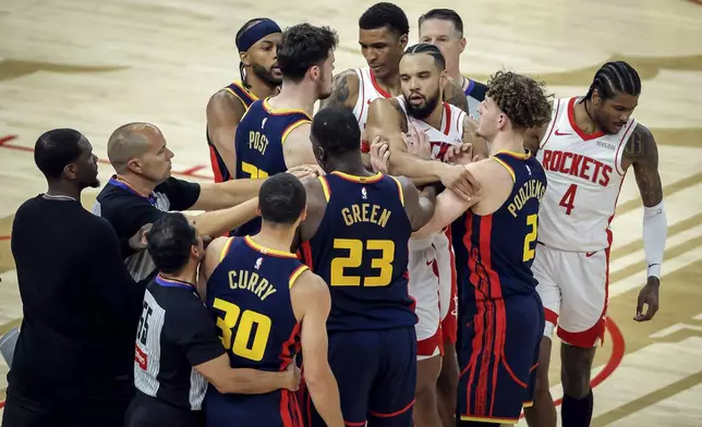 Referees and players try to break up the scrum as a fight broke out in the second quarter as the Golden State Warriors played the Houston Rockets during an NBA Playoffs' First Round Game 4 at Chase Center in San Francisco on Monday, April 28, 2025.(Carlos Avila Gonzalez/San Francisco Chronicle via AP)