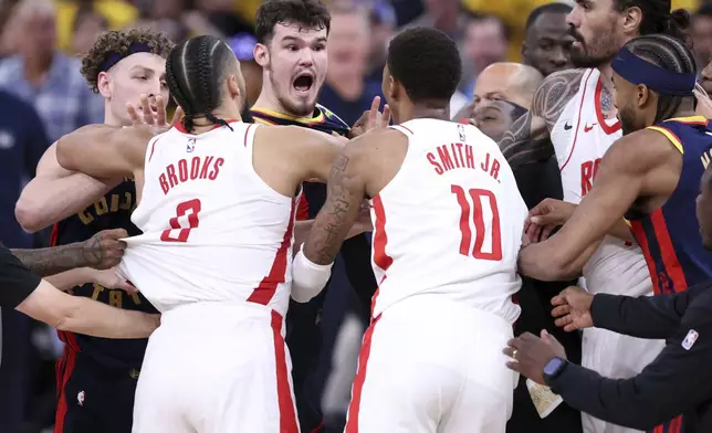 Golden State Warriors' Quentin Post scuffles with Houston Rockets' Jabari Smith, Jr. and Dillon Brooks in the second quarter of an NBA Playoffs' First Round Game 4 at Chase Center in San Francisco on Monday, April 28, 2025.(Scott Strazzante/San Francisco Chronicle via AP)