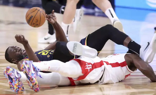 Golden State Warriors' Draymond Green tangles with Houston Rockets' Tari Eason during the first half in Game 4 of an NBA basketball first-round playoff series in San Francisco, on Monday, April 28, 2025. (Scott Strazzante/San Francisco Chronicle via AP)