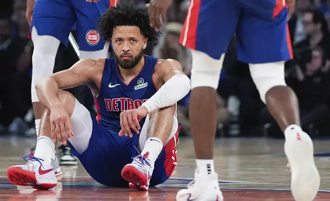 Detroit Pistons guard Cade Cunningham (2) sits after falling during the second half of Game 1 in an NBA basketball first-round playoff series against the New York Knicks, Saturday, April 19, 2025, in New York. (AP Photo/Julia Demaree Nikhinson)
