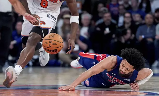 Detroit Pistons guard Cade Cunningham (2) falls during the second half of Game 1 in an NBA basketball first-round playoff series against the New York Knicks, Saturday, April 19, 2025, in New York. (AP Photo/Julia Demaree Nikhinson)