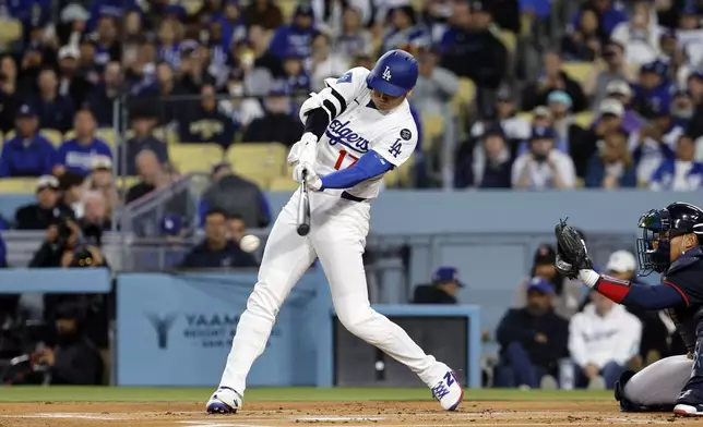 Los Angeles Dodgers' Shohei Ohtani hits a ground out against the Atlanta Braves during the first inning of a baseball game Tuesday, April 1, 2025, in, Los Angeles. (AP Photo/Kevork Djansezian)