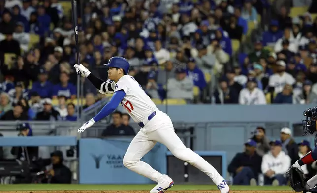 Los Angeles Dodgers' Shohei Ohtani hits a base hit against the Atlanta Braves during the sixth inning of a baseball game Tuesday, April 1, 2025, in, Los Angeles. (AP Photo/Kevork Djansezian)