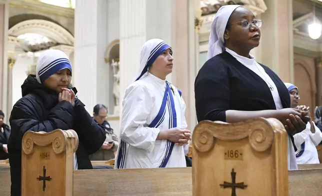 Church goers attend a mass to commemorate the late Pope Francis in Montreal, Saturday, April 26, 2025. (Graham Hughes /The Canadian Press via AP)