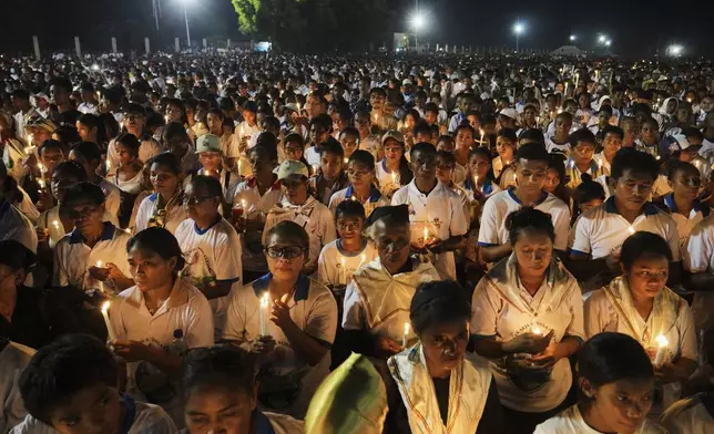 Devotees light candles during a Requiem Mass for the late Pope Francis, in Dili, East Timor, Saturday, April 26, 2025. (AP Photo/Firdia Lisnawati)