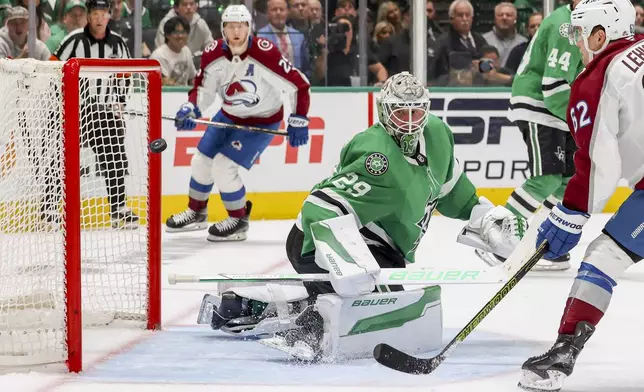 Colorado Avalanche left wing Artturi Lehkonen (62) scores past Dallas Stars goaltender Jake Oettinger (29) during the second period of Game 5 of a first-round NHL hockey playoff series in Dallas, Monday, April 28, 2025. (AP Photo/Gareth Patterson)