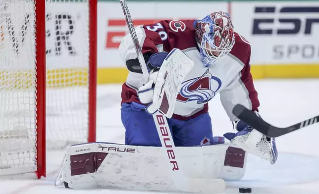 Colorado Avalanche goaltender Mackenzie Blackwood (39) stops a shot during a first-round NHL hockey playoff game against the Dallas Stars in Dallas, Monday, April 28, 2025. (AP Photo/Gareth Patterson)