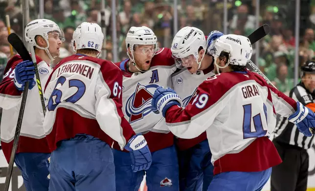 Colorado Avalanche's Artturi Lehkonen (62), Nathan MacKinnon (29), Josh Manson (42) and Samuel Girard (49) celebrate after Lehkonen's goal during the second period of Game 5 of a first-round NHL hockey playoff series against the Dallas Stars in Dallas, Monday, April 28, 2025. (AP Photo/Gareth Patterson)