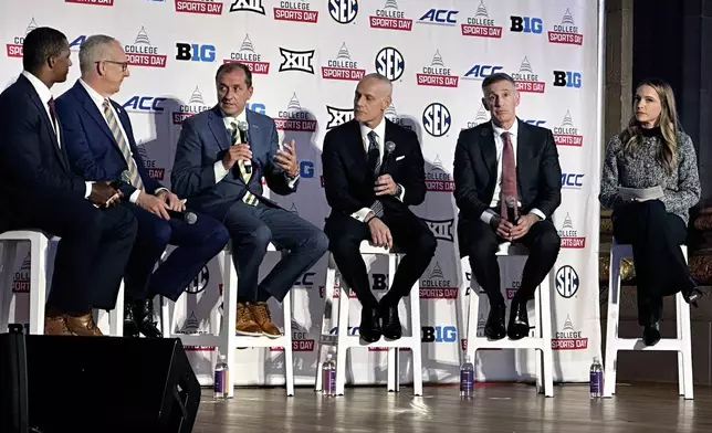 The Commissioners of the NCAA's power four conferences, SEC's Greg Sankey, ACC's Jim Phillips, Big 12's Brett Yormark and Big Ten's Tony Petitti speak with ESPN's Roddy Jones, left, and Dana Boyle, right, at the College Sports Day on Capitol Hill reception in Washington, D.C., on Wednesday, April 9, 2025, after they lobbied lawmakers earlier in the day for legislation to standardize name, image and likeness and other rules. (AP Photo/Stephen Whyno )