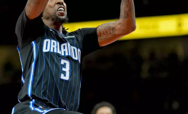 Orlando Magic guard Kentavious Caldwell-Pope (3) drives against the Atlanta Hawks during the first half of an NBA basketball game, Sunday, April 13, 2025, in Atlanta. (AP Photo/Mike Stewart)
