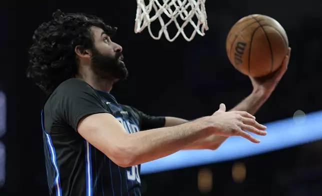 Orlando Magic center Goga Bitadze (35) shoots against the Atlanta Hawks during the first half of an NBA basketball game, Sunday, April 13, 2025, in Atlanta. (AP Photo/Mike Stewart)