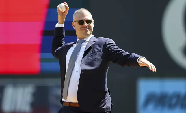 Former Minnesota Twins player Joe Mauer throws a ceremonial first pitch prior to a baseball game between the Minnesota Twins and the Detroit Tigers Sunday, April 13, 2025, in Minneapolis. (AP Photo/Matt Krohn)