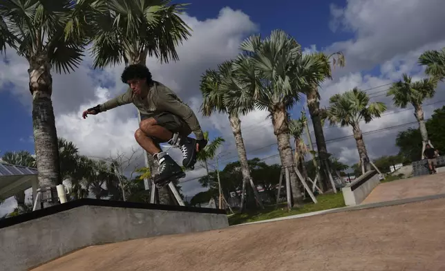 Reinaldo Schanz, a 19-year-old U.S. citizen who emmigrated from Venezuela at age 2, practices moves on his rollerblades after finishing work as a park service aide in Doral Central Park, Wednesday, April 2, 2025, in Doral, Fla. Schanz said his family supports the administration going after migrants with criminal records, but was surprised to see people on Temporary Protected Status (TPS) and similar programs targeted as well. (AP Photo/Rebecca Blackwell)