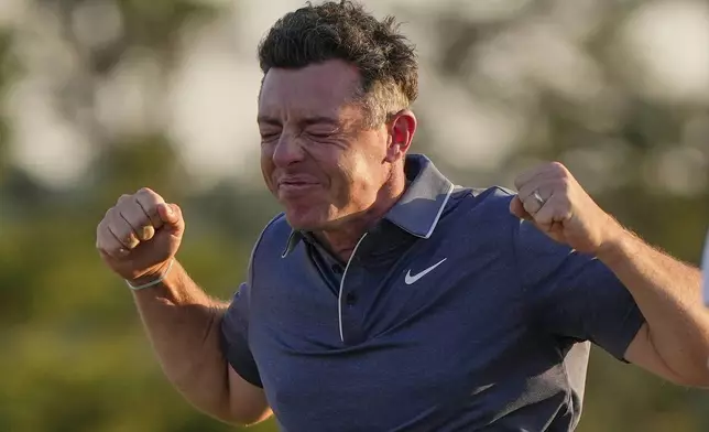 Rory McIlroy, of Northern Ireland, celebrates winning in a playoff against Justin Rose, of England, after the final round the Masters golf tournament, Sunday, April 13, 2025, in Augusta, Ga. (AP Photo/David J. Phillip)