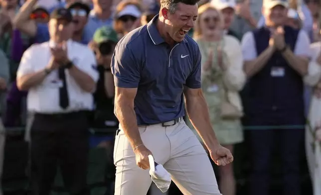 Rory McIlroy, of Northern Ireland, celebrates winning in a playoff against Justin Rose, of England, after the final round the Masters golf tournament, Sunday, April 13, 2025, in Augusta, Ga.(AP Photo/Ashley Landis)
