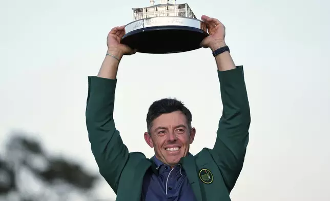 Winner Rory McIlroy, of Northern Ireland, holds the trophy at the Masters golf tournament, Sunday, April 13, 2025, in Augusta, Ga. (AP Photo/Ashley Landis)