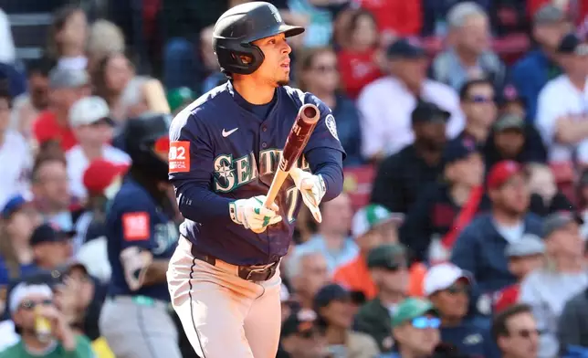 Seattle Mariners' Leo Rivas watches the ball as he runs to first base on a single during the seventh inning of a baseball game against the Boston Red Sox, Thursday, April 24, 2025, in Boston. (AP Photo/Mark Stockwell)