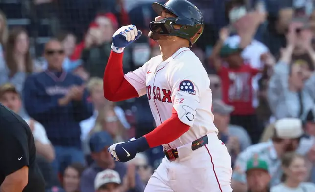 Boston Red Sox's Carlos Narváez gestures as he nears home plate after hitting a home run during the eighth inning of a baseball game against the Seattle Mariners, Thursday, April 24, 2025, in Boston. (AP Photo/Mark Stockwell)