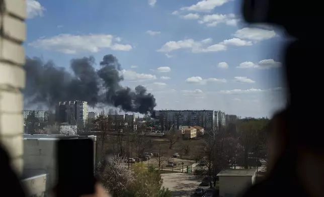 Smoke rises from an explosion following a Russian drone strike on Sumy, Ukraine, Monday, April 14, 2025. (AP Photo/Evgeniy Maloletka)