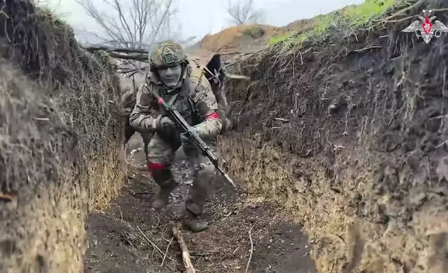 In this photo taken from video distributed by Russian Defense Ministry Press Service on Monday, April 14, 2025, Russian servicemen attend a combat training for assault units in an undisclosed location. (Russian Defense Ministry Press Service via AP)