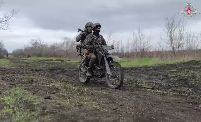 In this photo taken from video distributed by Russian Defense Ministry Press Service on Monday, April 14, 2025, Russian servicemen attend a combat training for assault units in an undisclosed location. (Russian Defense Ministry Press Service via AP)