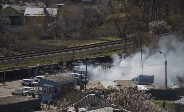 Smoke rises from an explosion following a Russian drone strike on Sumy, Ukraine, Monday, April 14, 2025. (AP Photo/Evgeniy Maloletka)