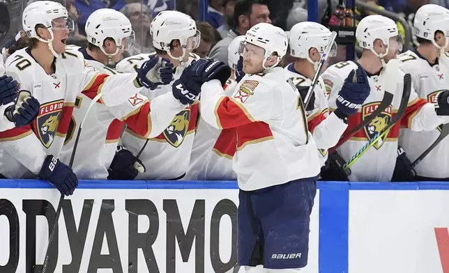 Florida Panthers left wing Matthew Tkachuk (19) celebrates with the bench after scoring against the Tampa Bay Lightning during the second period in Game 1 of an NHL hockey Stanley Cup first-round playoff series, Tuesday, April 22, 2025, in Tampa, Fla. (AP Photo/Chris O'Meara)
