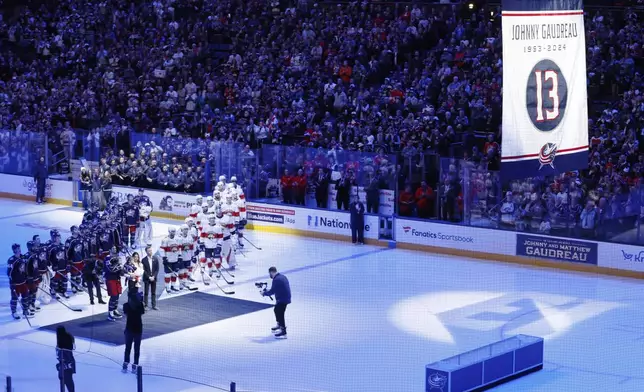 FILE - Blue Jackets' Johnny Gaudreau's family watches a #13 banner being raised during a ceremony before the start of an NHL hockey game between the Columbus Blue Jackets and the Florida Panthers. Tuesday, Oct. 15, 2024, in Columbus, Ohio. (AP Photo/Jay LaPrete, File)