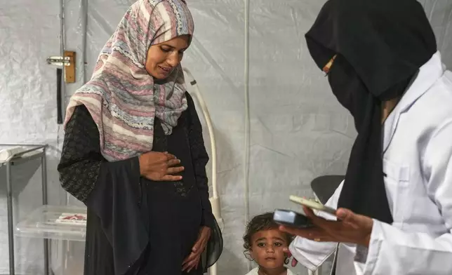 Islam Qeshta, a 30-year-old pregnant Palestinian woman, arrives for a prenatal checkup at the MSF clinic in Muwasi, near Khan Younis, in the southern Gaza Strip, on Wednesday, April 9, 2025. (AP Photo/Abdel Kareem Hana)
