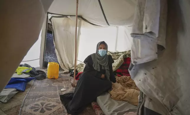 Palestinian woman Yasmine Siam, who was pregnant but suffered a miscarriage a few days later, poses for a photo in her tent in Khan Younis, southern Gaza Strip, Wednesday, April 9, 2025. (AP Photo/Abdel Kareem Hana)
