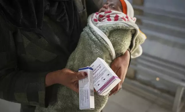 Huda Kabaja, 26, holds her 3-week-old daughter while receiving medication for malnutrition at the Médecins Sans Frontières (MSF) clinic in Muwasi, near Khan Younis in the southern Gaza Strip, Wednesday, April 9, 2025. (AP Photo/Abdel Kareem Hana)