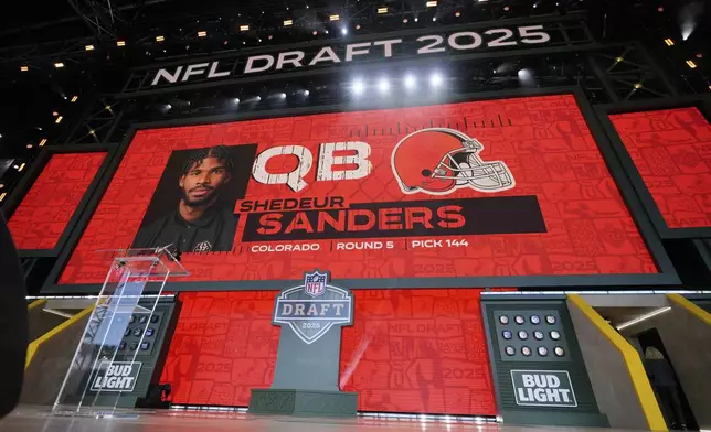 A screen shows Colorado quarterback Shedeur Sanders after being chosen by the Cleveland Browns with the 144th overall pick during the third day of the NFL football draft, Saturday, April 26, 2025, in Green Bay, Wis. (AP Photo/Jeff Roberson)