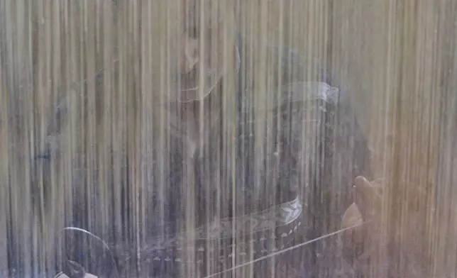 Mohammad Yousaf Dar weaves a Kashmiri hand-knotted carpet at his home in Srinagar, Indian controlled Kashmir, on April 12, 2025. (AP Photo/Dar Yasin)